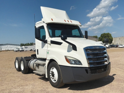 Freightliner Cascadia126 conventional daycab truck in white viewed from front-left with sleeper cab, flatbed absent.