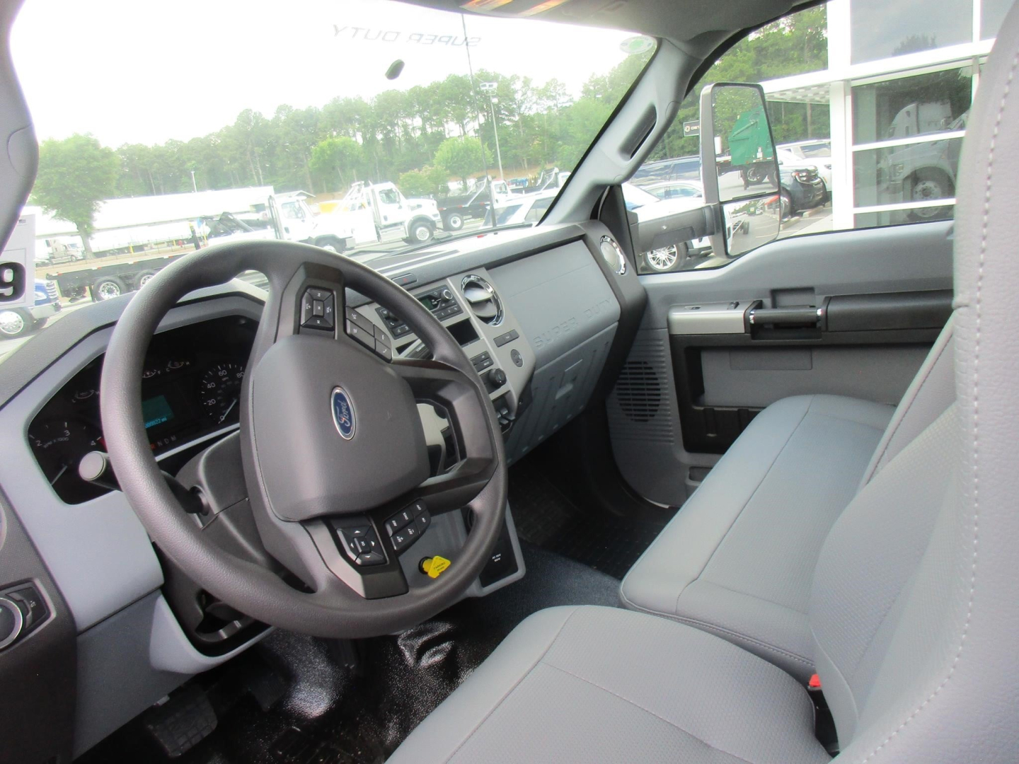 Ford F-750 Cab and Chassis interior showing steering wheel, dashboard, and front seats.