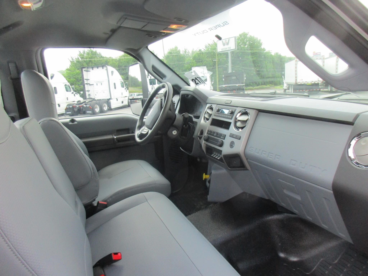 Ford F-750 Cab and Chassis interior view showing steering wheel, dashboard, and front seats.