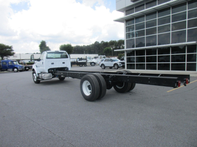 Ford F750 SD cab and chassis chassis frame with long wheelbase, white cab, in dealership lot.