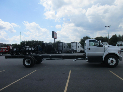 Ford F750 SD cab and chassis truck side view showing chassis frame and white cab with long wheelbase.