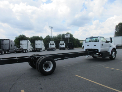 Ford F-750 SD cab and chassis truck in a dealership lot with multiple trucks in background.