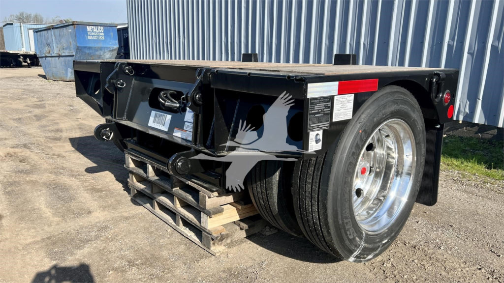Trailer frame showing a Fontaine Renegade lowboy trailer with dual rear wheels, stickers, and warning labels on the frame.