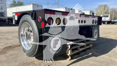  Fontaine flip axle trailer in new condition showing rear wheel and dual axle deck with red and amber lights and sturdy steel frame.
