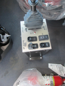 Dump truck gear selector console with multiple switches and shifter in a Western Star 49X cab; appears to be a control panel with labeled buttons.