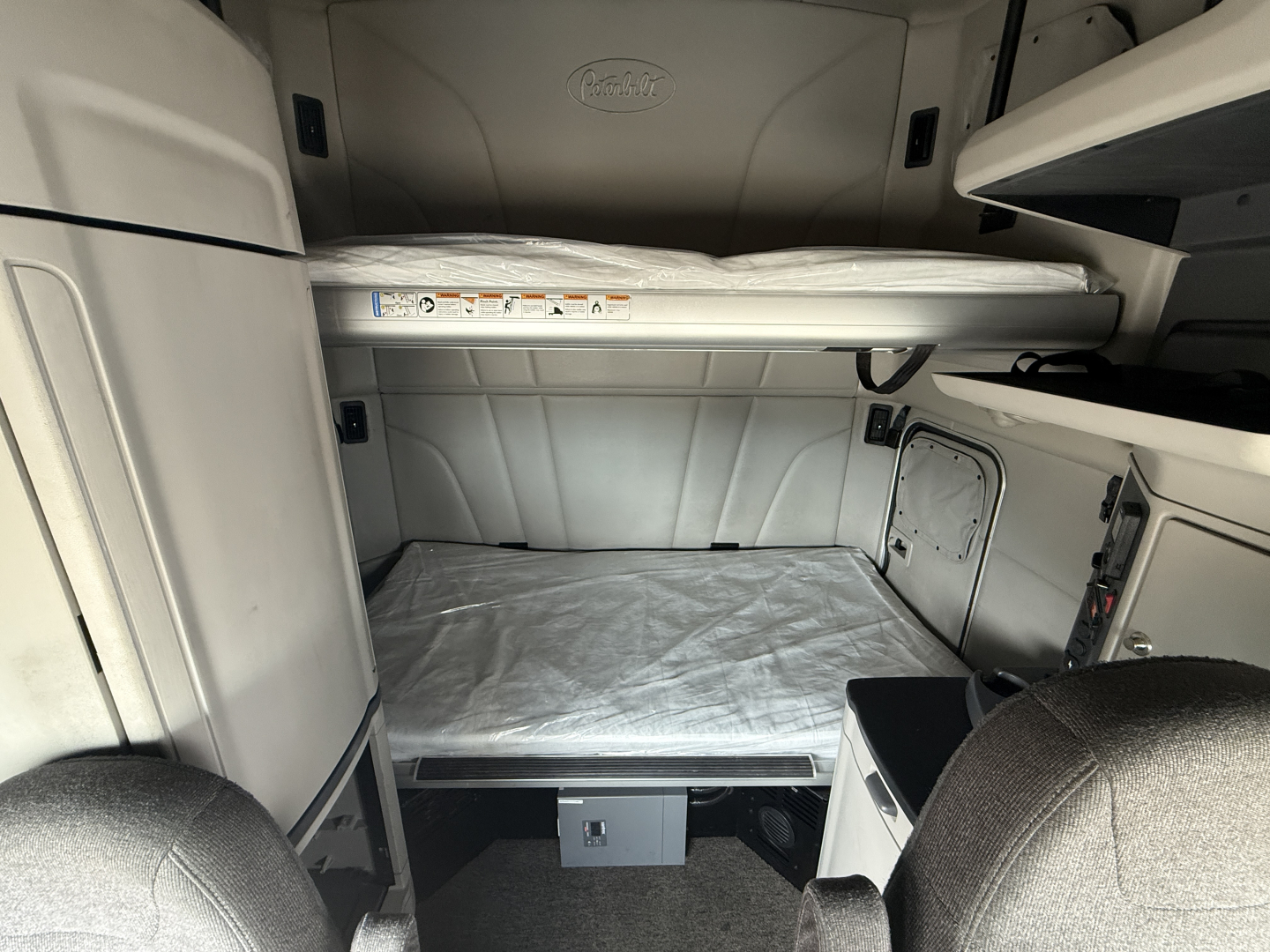 Peterbilt 579 sleeper cab interior with bunk beds and storage compartments visible.