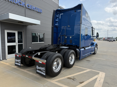 Peterbilt 579 truck in blue, rear view showing fifth wheel and dual rear axles, stock number B3163P, VIN 1XPBD49X0ND770704, conventional sleeper tractor at dealership.