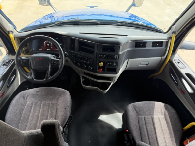 Peterbilt 579 truck interior view from driver seat showing steering wheel, dashboard, and center console with gauges and controls.