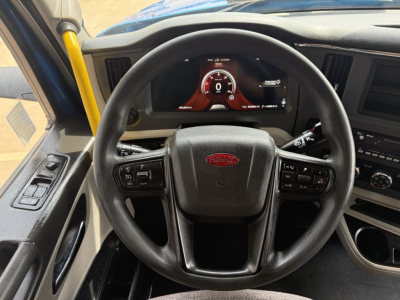 Peterbilt 579 truck interior showing steering wheel and digital gauge cluster