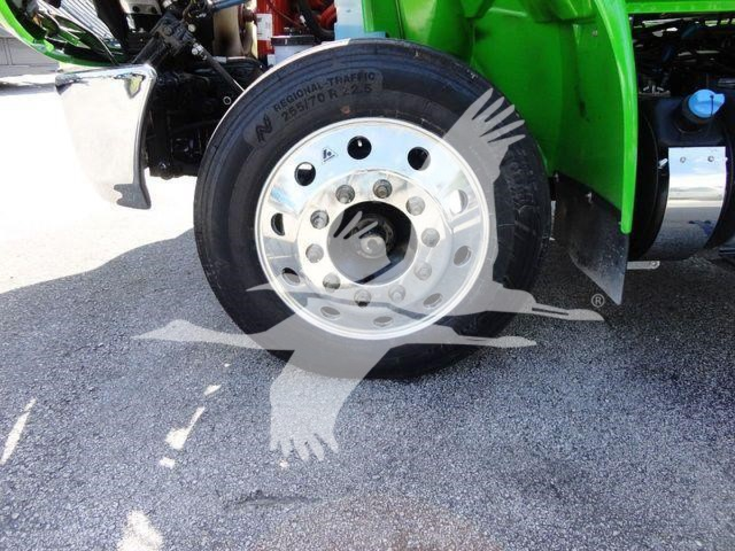 Wheel and tire of a 2023 International MV chassis showing steel wheel and black tire with lettering.