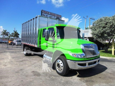 Green 2023 International MV truck in a lot, cab front right view, aluminum cargo body, stock number MVEXCABCHIP16.