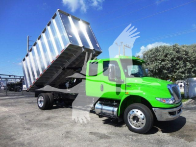Green 2023 International MV dump truck in tilted aluminum dump bed with branding and stock overlay