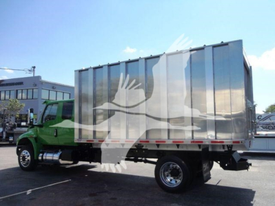 Truck at a dealership showing a silver cargo box on a green International MV cab. Visible text includes stock number MVEXCABCHIP16 and category/type hints in listing.