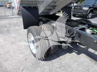 MVEXCABCHIP16 International MV dump truck chassis showing rear dual wheels and suspension with parts, no cab image.