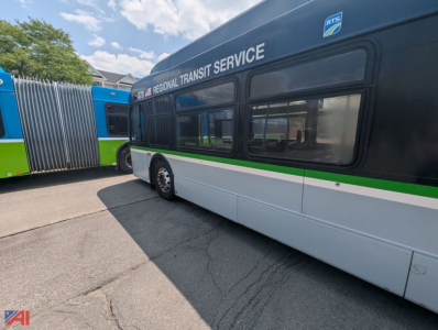 Bus side of 2013 New Flyer Xcelsior transit bus with Regional Transit Service livery and green stripe