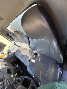 Cab interior of a 2020 International MV box truck showing driver seat and dashboard