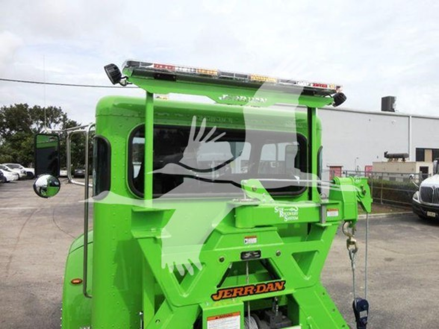 Green Peterbilt rollback truck from rear-right view showing JERR-DAN equipment and bumper text.