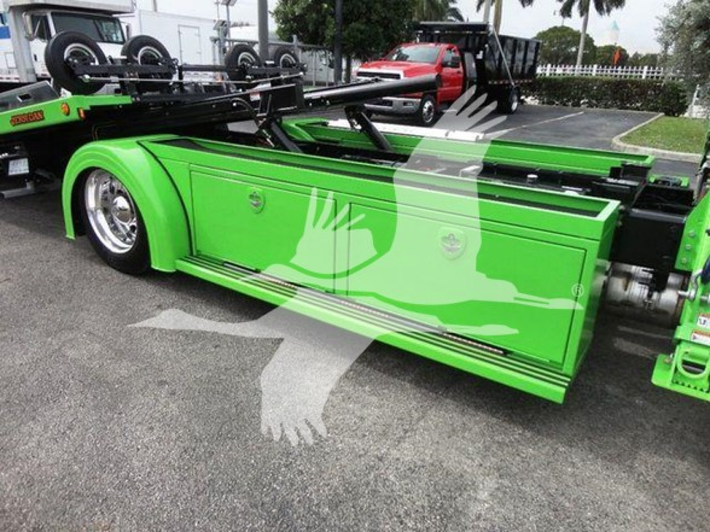 Peterbilt 337 rollback truck side view showing bright green cabin doors and undercarriage, with chrome wheel rims.