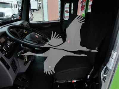 Peterbilt 337 truck interior with steering wheel and driver's seat visible; watermark of a bird logo overlays the image.