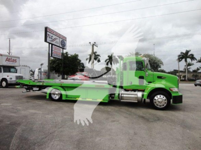 Peterbilt 337 rollback truck in green with flatbed, side view showing cab and wheels.