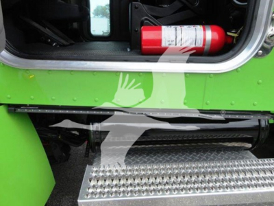 Peterbilt 337 rollback truck interior area with bright green body, open cab door, fire extinguisher, and aluminum diamond plate step.
