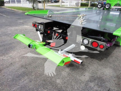 Truck rollback bed with green hitch extension and rear lights visible; platform with diamond plate; VIN/stock area not readable.