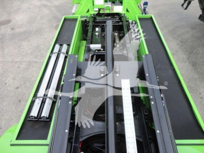 Green Peterbilt rollback bed with metal rails and measurement scale showing the bed and hydraulic components.
