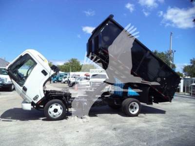 Isuzu NRR Dump Truck in-service with cargo bed raised, front cab visible, white cab and black dump bed.