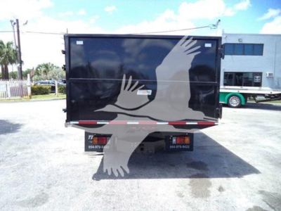 Isuzu truck dump body rear view with black box and white silhouetted birds graphic on tailgate. No visible text discernible on the tailgate.
