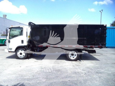 Isuzu NRR dump truck side view showing black cargo bed and white cab with stock number T302008FM visible.