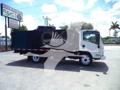 Isuzu NRR dump truck side view showing cargo bed and cab with white front and dark cargo area on dealership lot.
