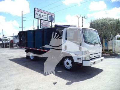 Isuzu NPR/NRR truck in yard with dump body, side view showing cab and cargo bed.