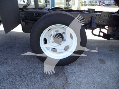 Isuzu NRR truck chassis with front wheel visible and white steel rim; no legible labels visible on components.