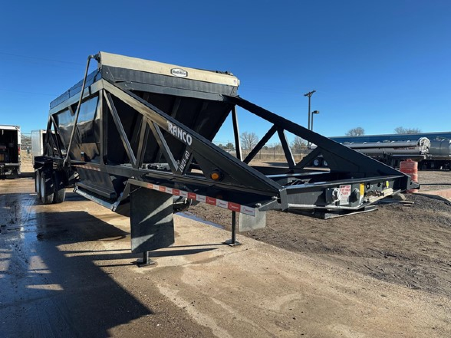 Ranco LW21-40 trailer in-service showing black powder-coated frame and elevated gooseneck with storage box.