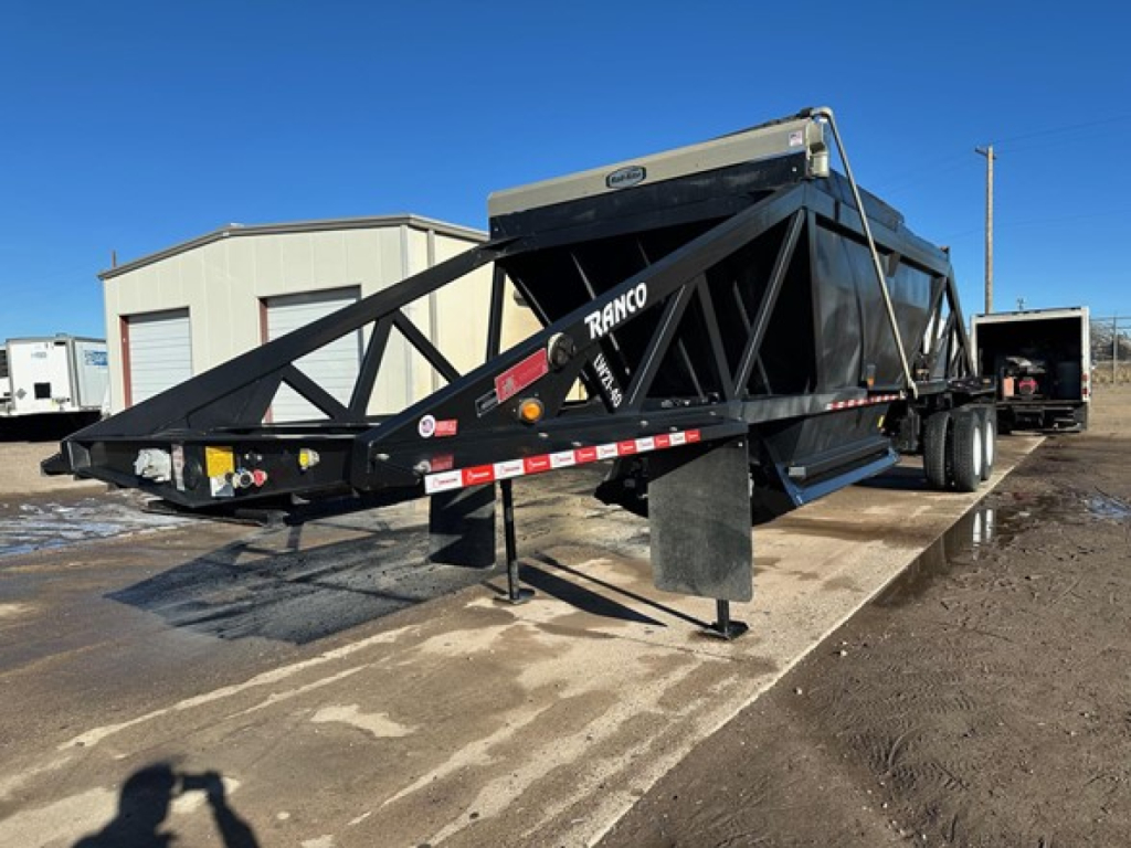 Ranco LW21-40 trailer in loaded position showing steel truss frame and hopper with dual-axle setup.