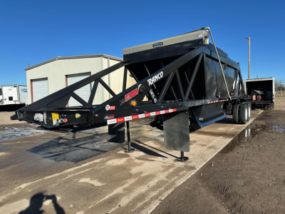 Ranco LW21-40 dump trailer side view showing triangular truss frame and hopper with support legs and dual rear wheels.