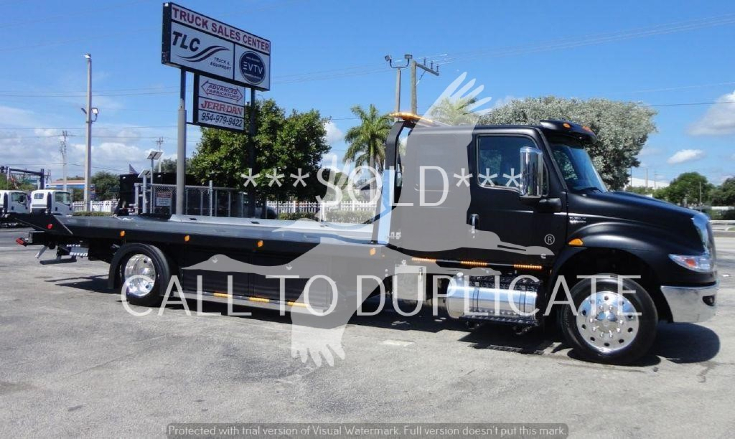 International MV rollback truck with flatbed showing VIN 1HTEUMML7NH043803 and stock number J43803.