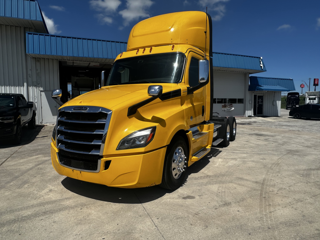 Yellow 2019 Freightliner Cascadia 126 conventional daycab front-left view with sleeper top, chrome grille, and large side mirrors.