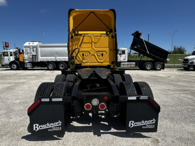 Rear view of a 2019 Freightliner Cascadia 126 truck with a yellow cab at the top and a black chassis showing mud flaps with Bruckner's Truck Equipment logos.