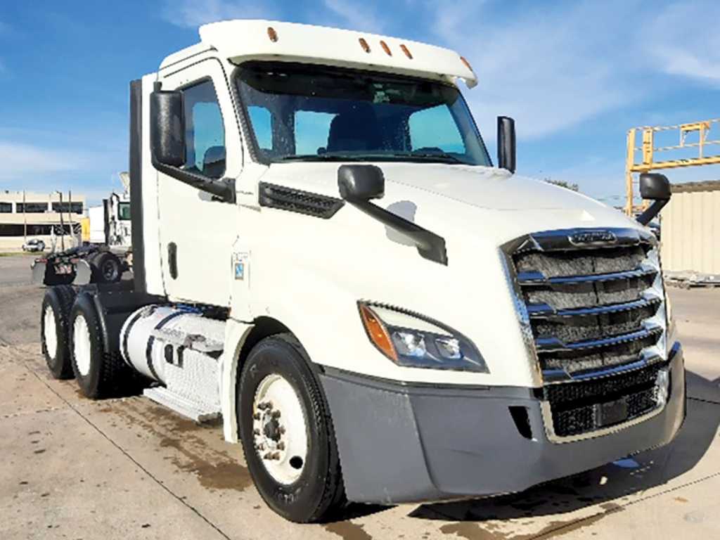 Freightliner Cascadia126 daycab tractor front-right view showing white cab, grille, headlights, mirrors, and fuel tanks.
