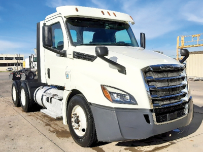 Freightliner Cascadia126 daycab tractor front-right view showing white cab, grille, headlights, mirrors, and fuel tanks.