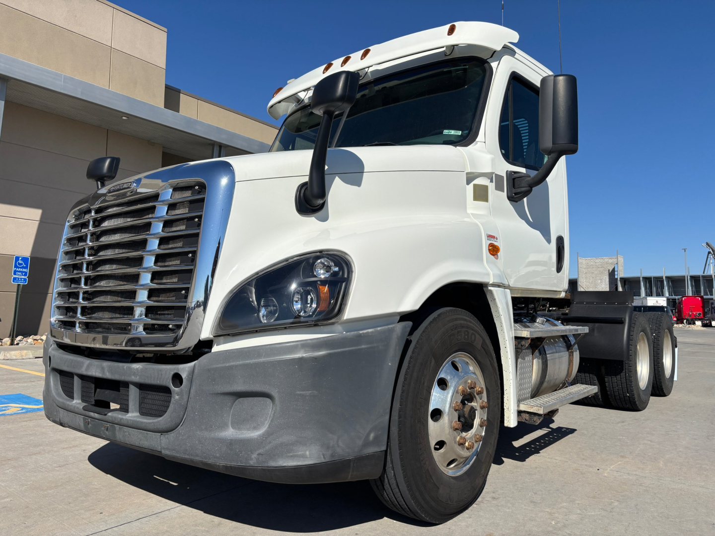 Truck front-left view of a white 2017 Freightliner CA12564DC conventional daycab showing cab, grille, headlights, front bumper, and dual rear wheels with chrome fuel tanks.