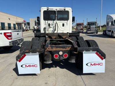 Rear view of 2017 Freightliner CA12564DC tractor chassis showing mud flaps with MHC logos, dual rear axles, and fifth-wheel area.