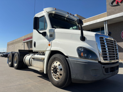 Freightliner CA12564DC truck cab and chassis showing front grille with Freightliner logo, side mirrors, and cargo fuel tanks; no legible serials or stickers visible in this view.