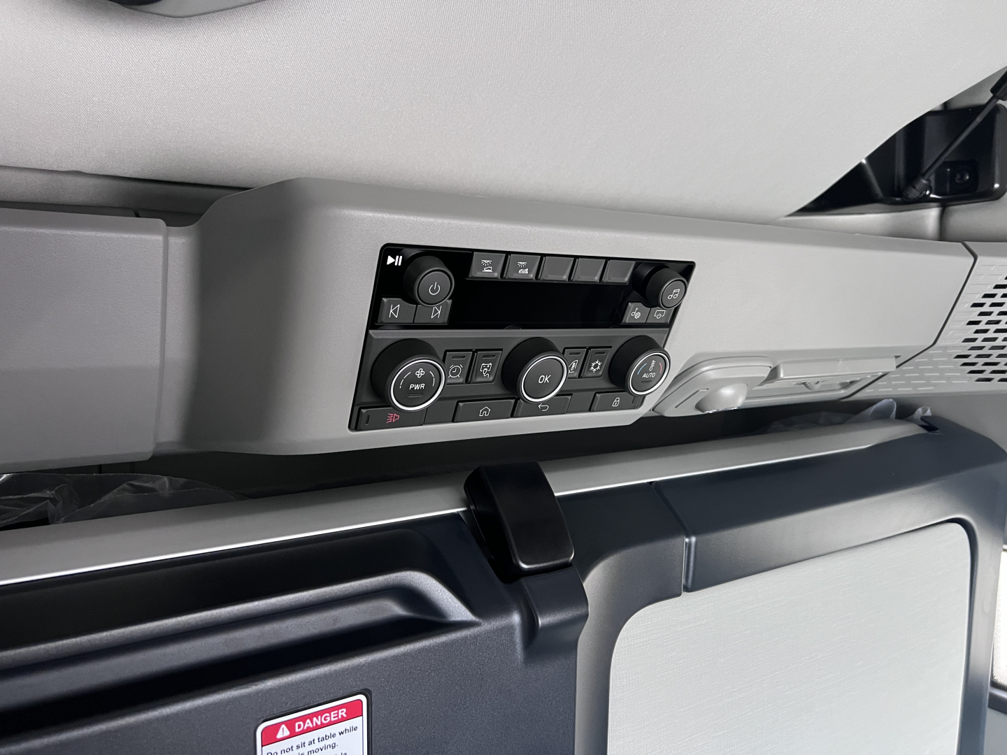 Dashboard controls and vents in a Volvo VNL interior showing climate controls, radio area, and center console.
