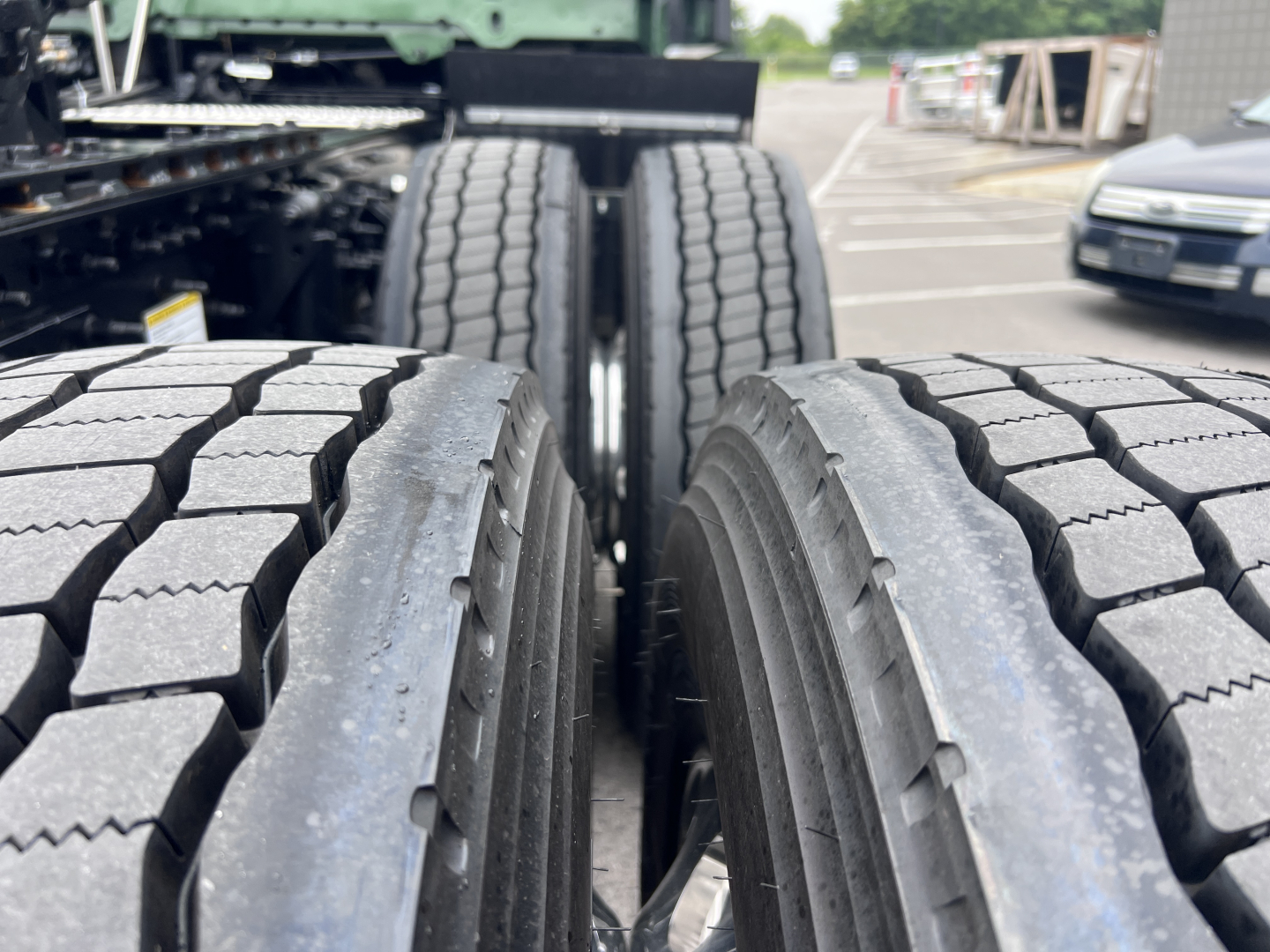 Truck rear dual tires on Volvo VNL configuration showing tread detail and wheel alignment.