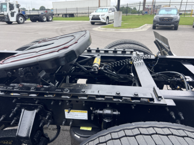 Truck chassis and fifth wheel coupling area showing suspension components and air lines