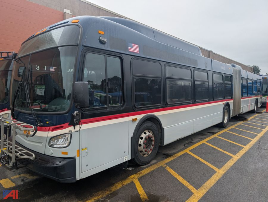 Bus exterior showing 2013 New Flyer XD60 transit bus with gray body, white lower section, red stripe, side windows, and front handlebars.