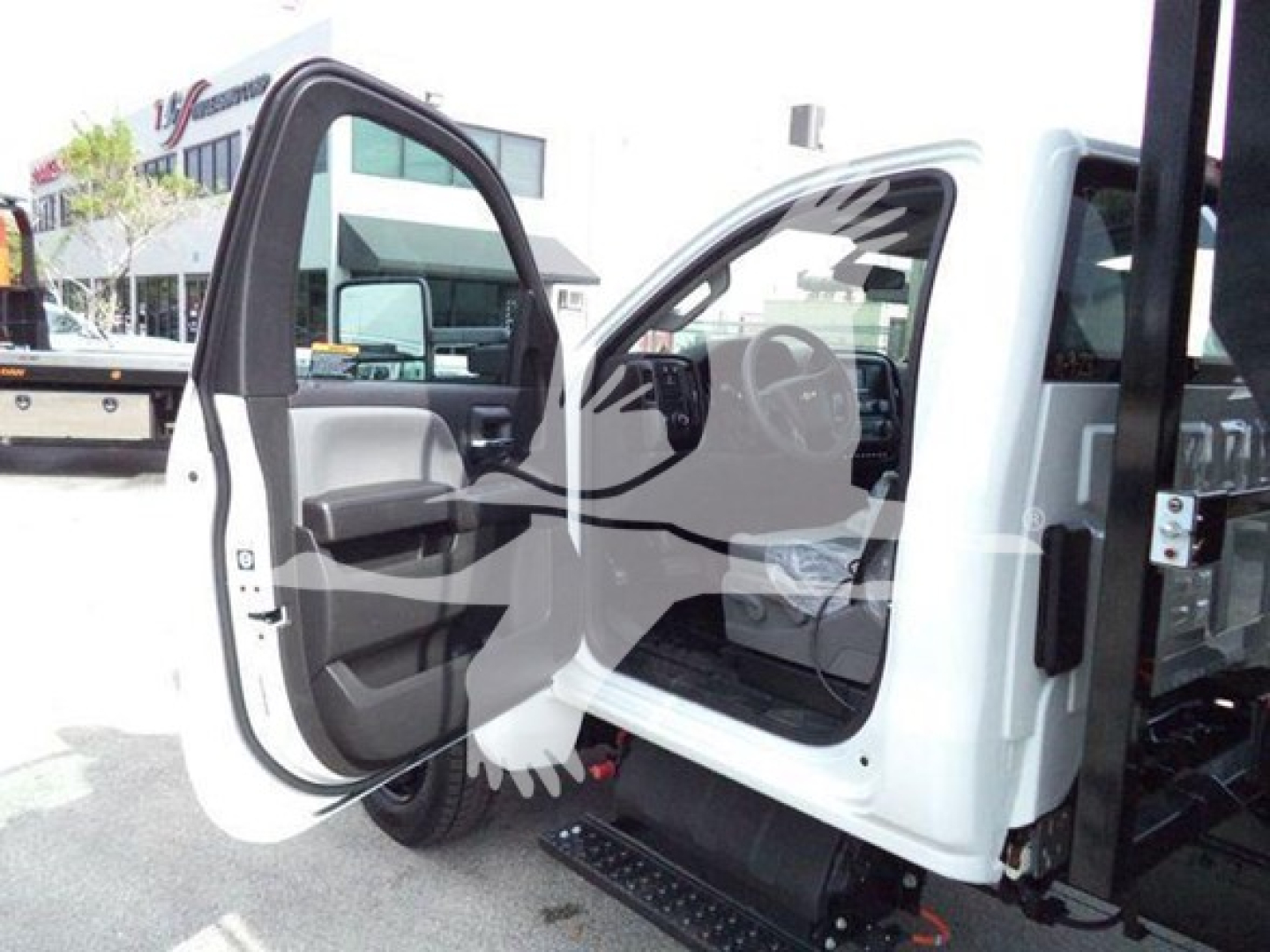 Dashboard area of a 2023 Chevrolet Silverado 6500HD cab showing open driver door and interior features.