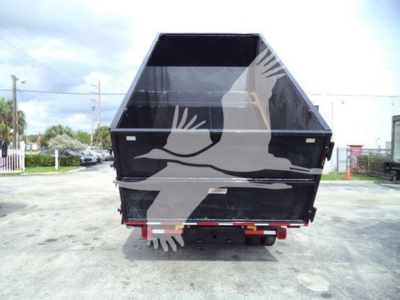 Dump truck bed with black-and-gray graphics on the site showing rear view of a dump body attached to a Silverado 6500HD chassis.